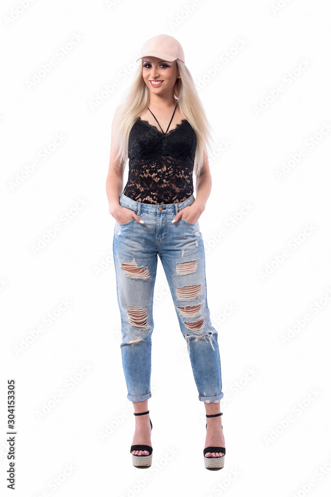 Blonde pretty young woman in casual street style modern clothes posing with hands in pockets. Full body isolated on white background. Blonde pretty young woman in casual street style modern clothes posing with hands in pockets. Full body isolated on white background.