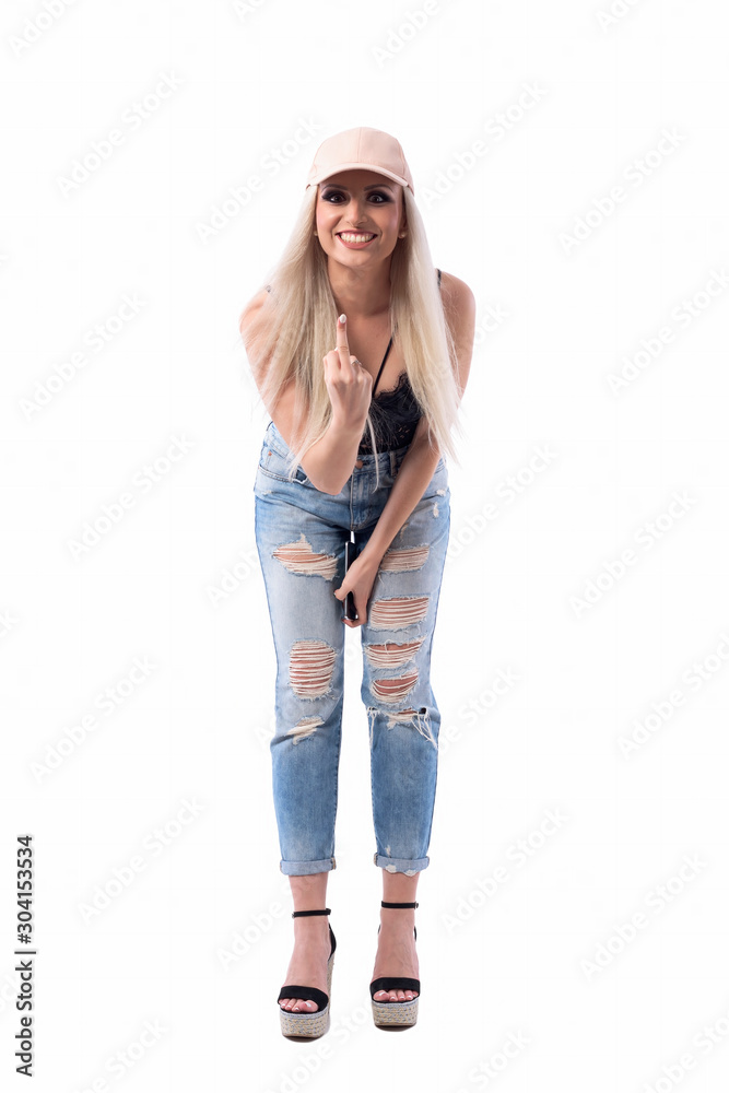 Expressive young funky modern blonde girls showing rude middle finger symbol at camera while bending forward. Full body isolated on white background. Expressive young funky modern blonde girls showing rude middle finger symbol at camera while bending forward. Full body isolated on white background.
