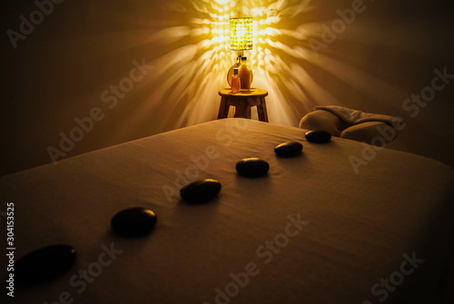 Professional massage relaxation lights and hot stones with coconut oil