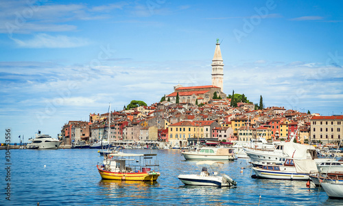 Scenic panoramic view of famous old town of Rovinj, a historic Mediterranean city in the north Adriatic sea, seen from busy tourist harbour area on a beautiful sunny day with blue sky, Istria, Croatia