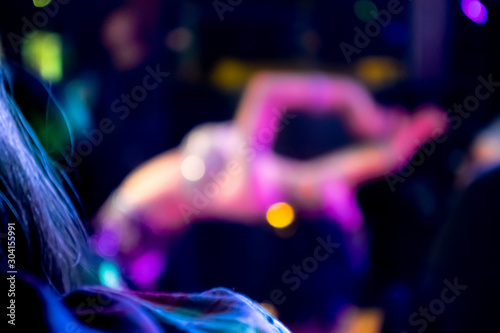 Billede på lærred A softly blurred, beautiful female belly dancer with a sequined bra leans back w