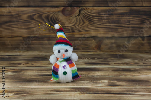 Snowman toy on wooden background