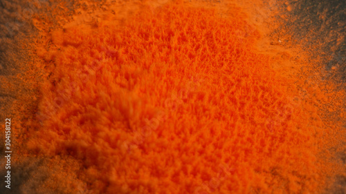 Explosion of orange powdered paint 