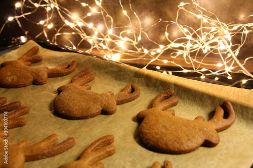 Christmas - baking gingerbread - cutted gingerbreads on reindeer form on baking tray