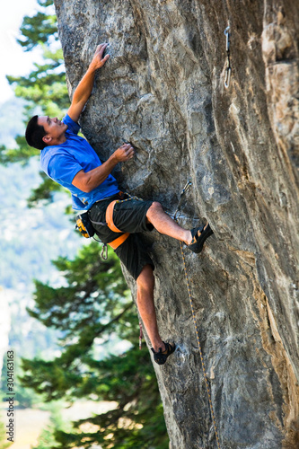 A man cruises Kraken (5.12c) at Natural Bridge State Park. photo