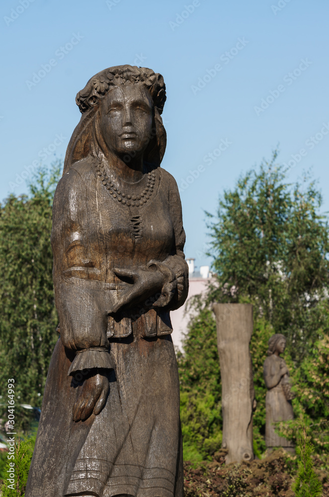 Pinsk, Belarus - August 26, 2019. Wooden figures on the pedestrian street named after Lenin in Pinsk.