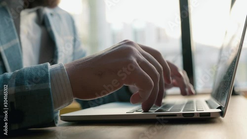 hands typing on computer keyboard, moving camera, business man working on laptop pc in office.