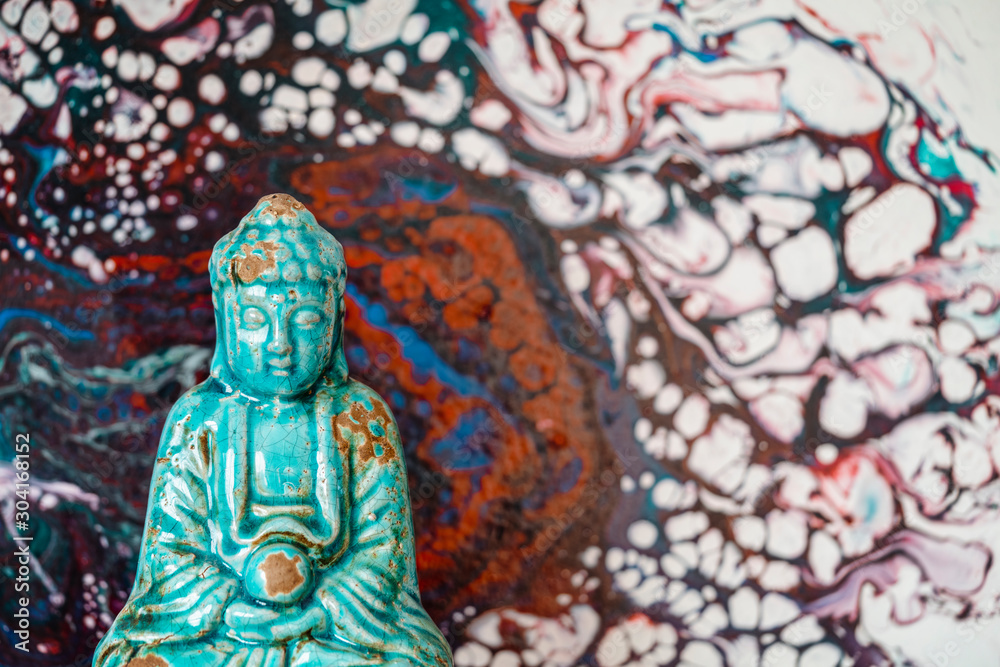Fototapeta premium Buddha figurine on abstract pattern background