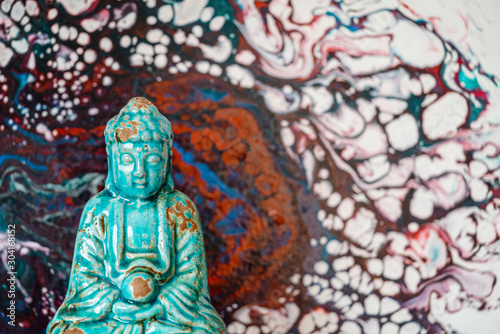 Buddha figurine on abstract pattern background