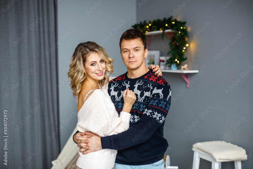 Happy young couple parents spend time together on Christmas Eve and New Year. New year holidays