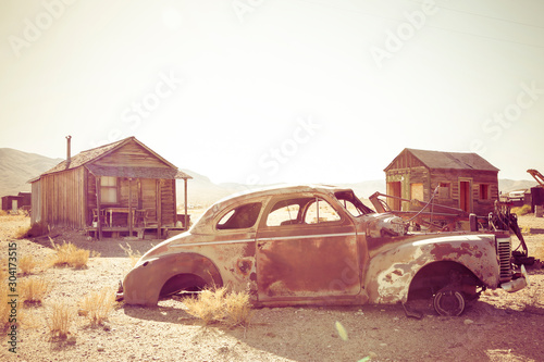 Old rusted car and abandoned buildings. Goldpoint, Nevada, USA photo