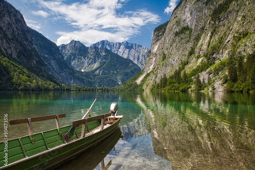 lake Obersee with boat and view at mountains alps