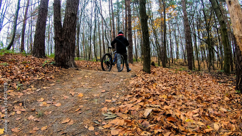 Amateur rider on the bicycle in the autumn park