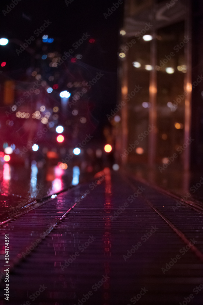 traffic in city at night with grate in focus traffic in city at night with grate in focus