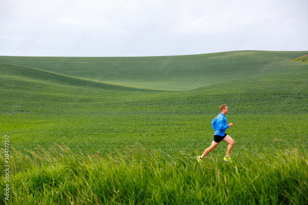 A man running on a stormy spring day in north Idaho.