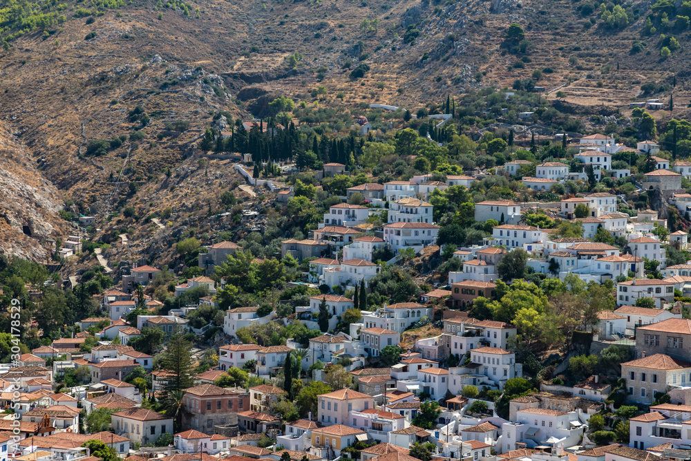 Houses and buildings in the mountains with trees and vegetation in Hydra Island