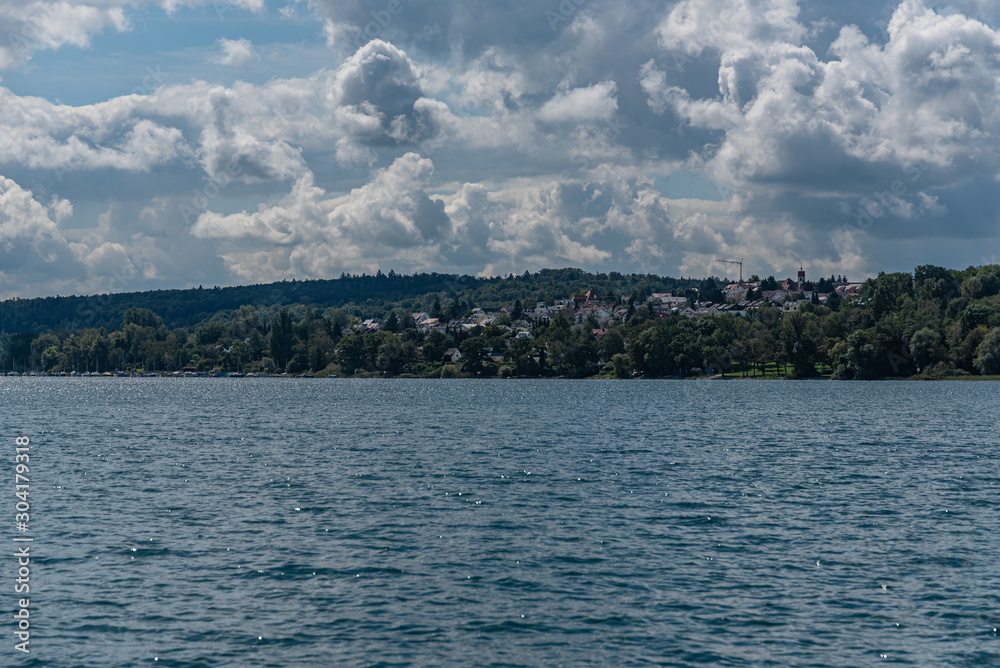 The shoreline at lake constance with clouds in the background