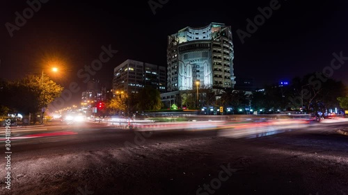 Traffic in front of office towers in Connaught Place in New Delhi downtown time lapse at night