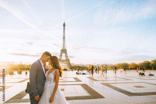 Photography Happy romantic married couple hugging near the Eiffel tower in Paris