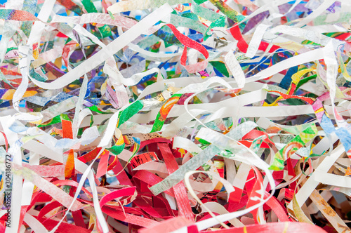 Closeup shredded paper texture and reuse colorful paper scrap of document background. Selective focus image..