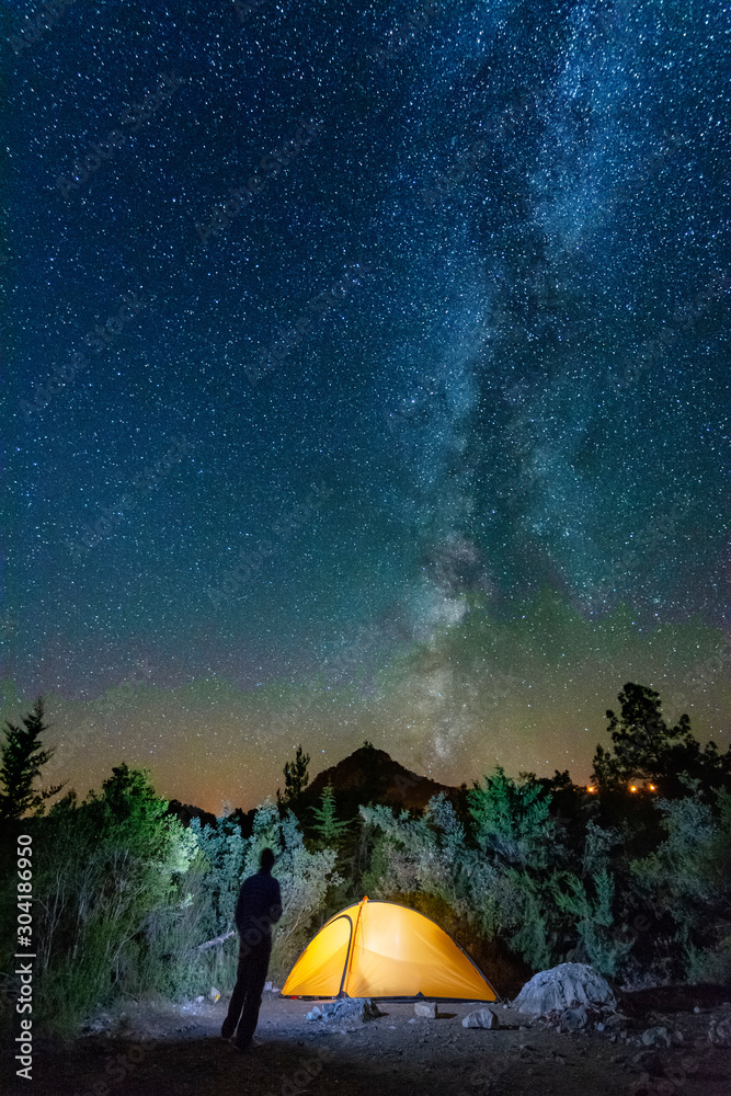 Naklejka starry night with the Milky Way on the Turkish Mediterranean coast amidst the rocky mountains with tourists in a yellow tent