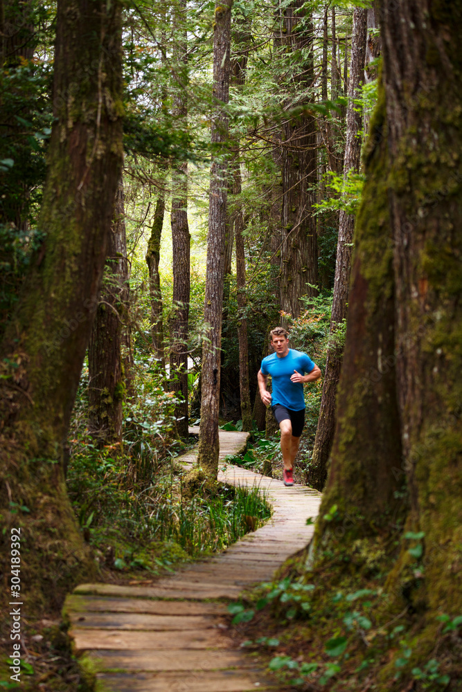 A man trailrunning along the Sand Point Trail near Ozette, Washington in the Olympic National Park. A man trailrunning along the Sand Point Trail near Ozette, Washington in the Olympic National Park.