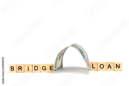 Bridge loans- word composed fromwooden blocks letters on White background, copy space for ad text. photo