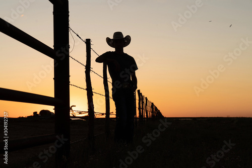 silhouette of cowboy in sunset