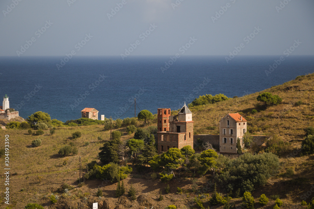 old houses on the hill with sea in the background