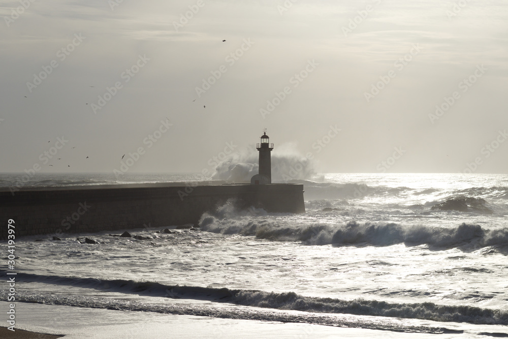 lighthouse with rough waves as background