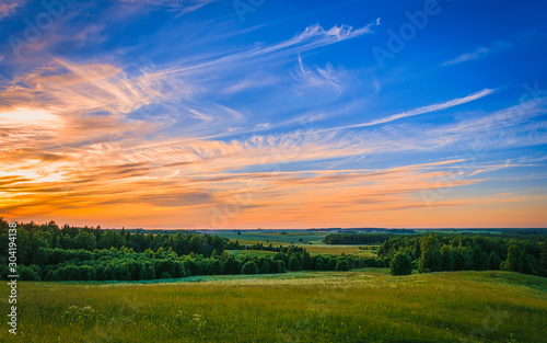 sunset over green field