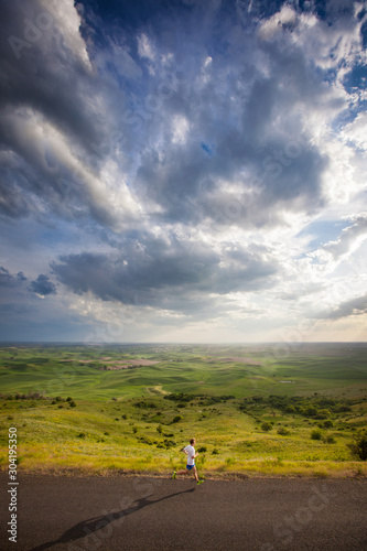 Wallpaper Mural Distance runner  on a late afternoon run on the scenic windy road up Steptoe Butte State Park in eastern Washington state in peak spring conditions. Torontodigital.ca