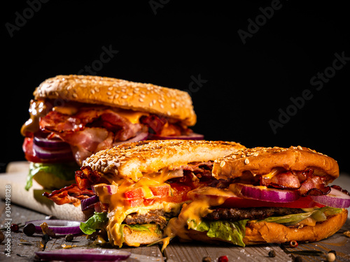 Bacon burger with beef patty on wooden table
