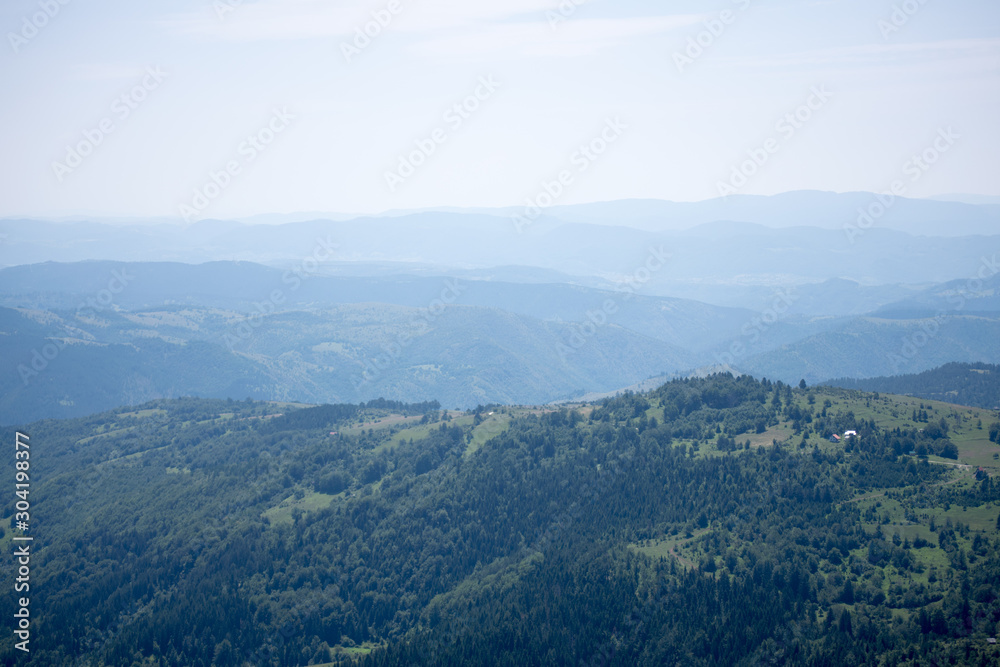 summer landscape with clouds, hills, meadow and forest in Zlatibor mountain area, Serbia