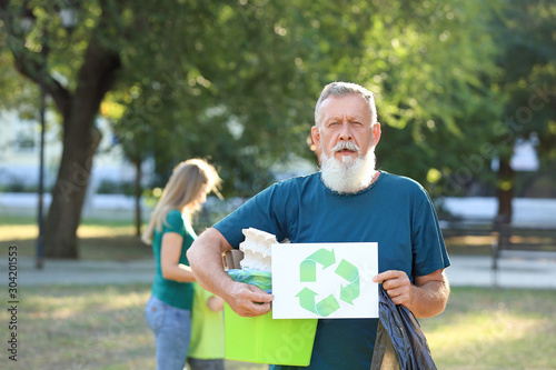 Man holding gathered garbag...