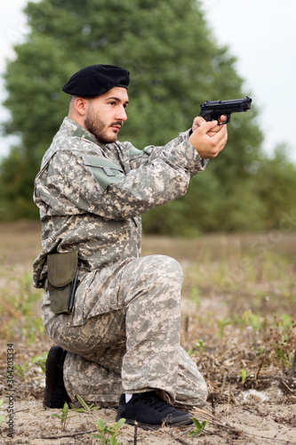 military person holding pistol