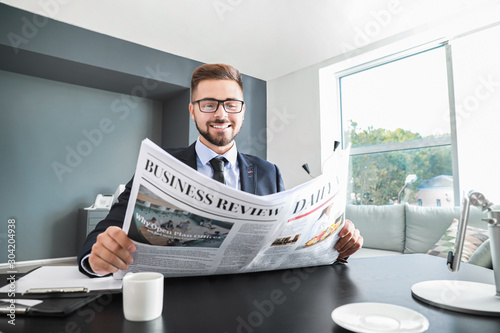 Handsome businessman readin...