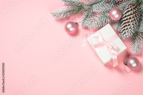 Christmas flat lay background with christmas present box on pink.