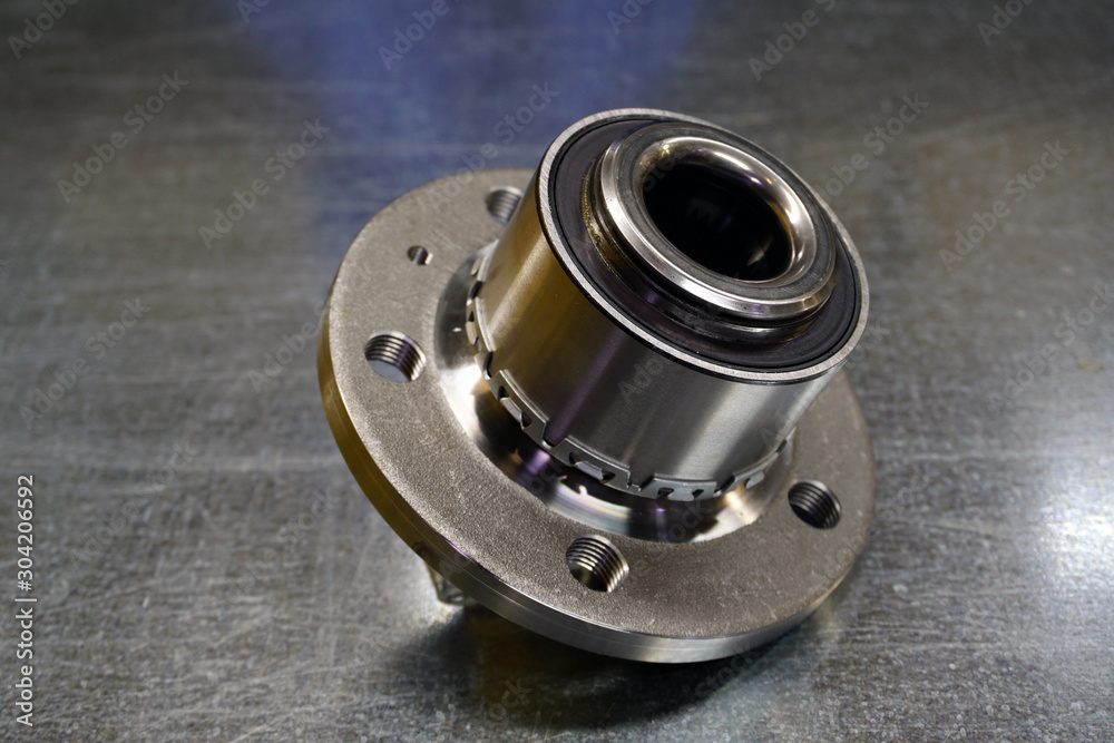 New wheel hub assembly with bearing. This is part of the car suspension on a steel background with a gradient. The concept of new car parts. Service of modern cars. New wheel hub assembly with bearing. This is part of the car suspension on a steel background with a gradient. The concept of new car parts. Service of modern cars.