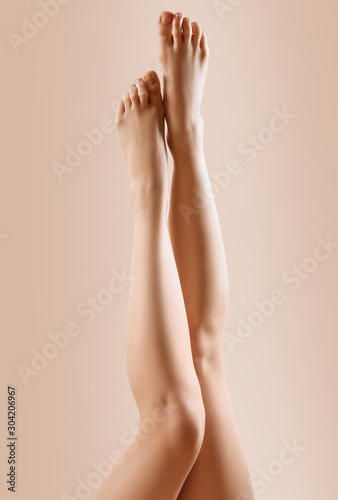 Beautiful female legs upside down. © Galaxy_love_design