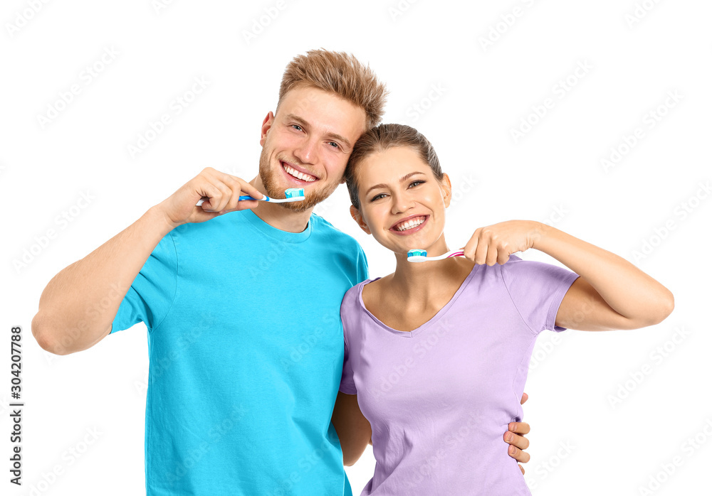 Young couple brushing teeth on white background Young couple brushing teeth on white background