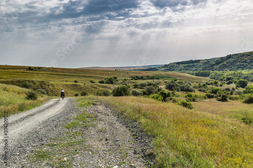 Biker on green hills in holiday