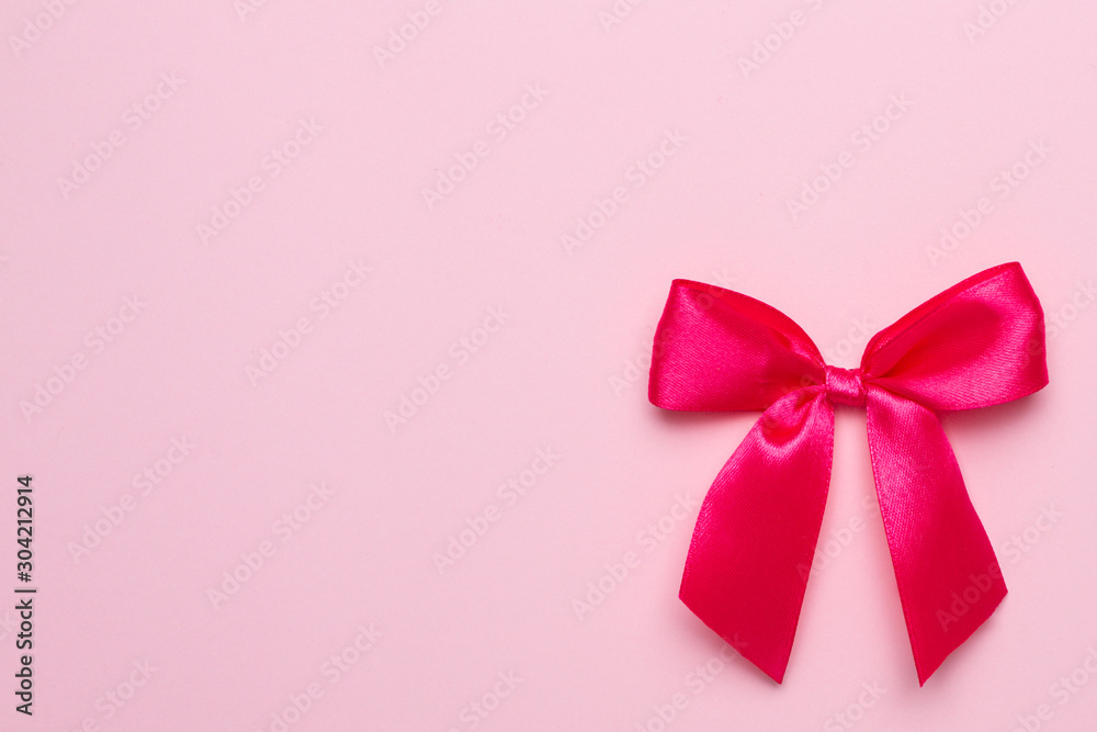 Pink pastel background and gift satin ribbon bow copyspace Pink pastel background and gift satin ribbon bow copyspace