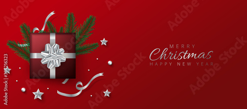 Red header or banner design decorated with gift box, baubles and pine leaves for Merry Christmas and Happy New Year.