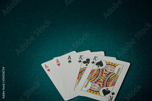 view of a game table with green carpet where are the cards with full of aces and kings