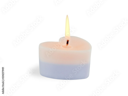 Heart shaped pink and purple burning candle isolated on white background. Valentines day concept. 