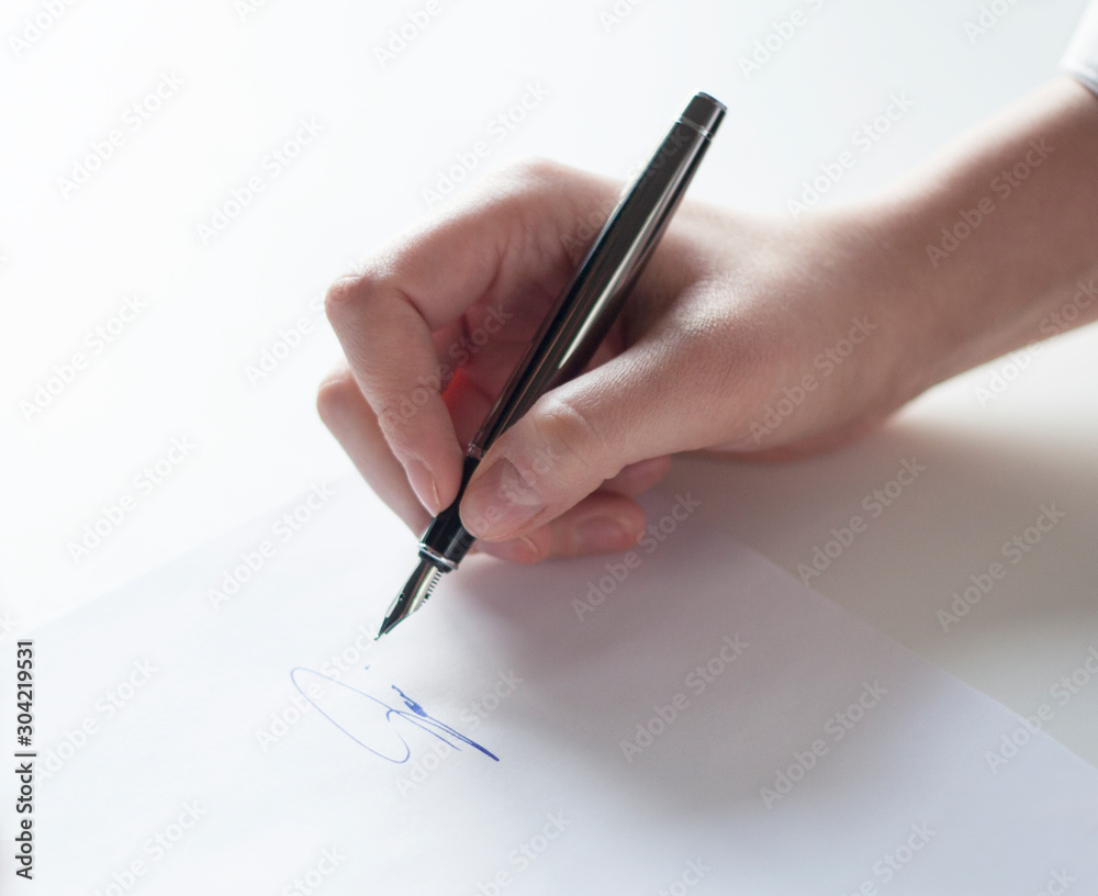 hand with pen signing a document hand with pen signing a document