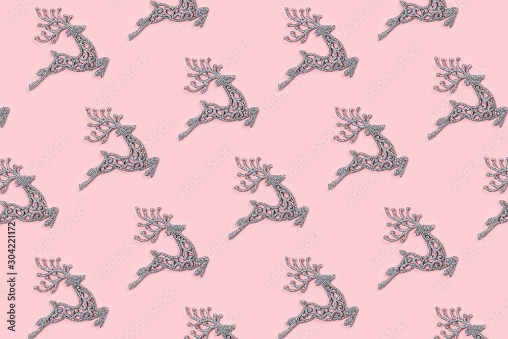 Pattern made of white christmas deer decoration on pastel pink background. Christmas concept. Pattern made of white christmas deer decoration on pastel pink background. Christmas concept.