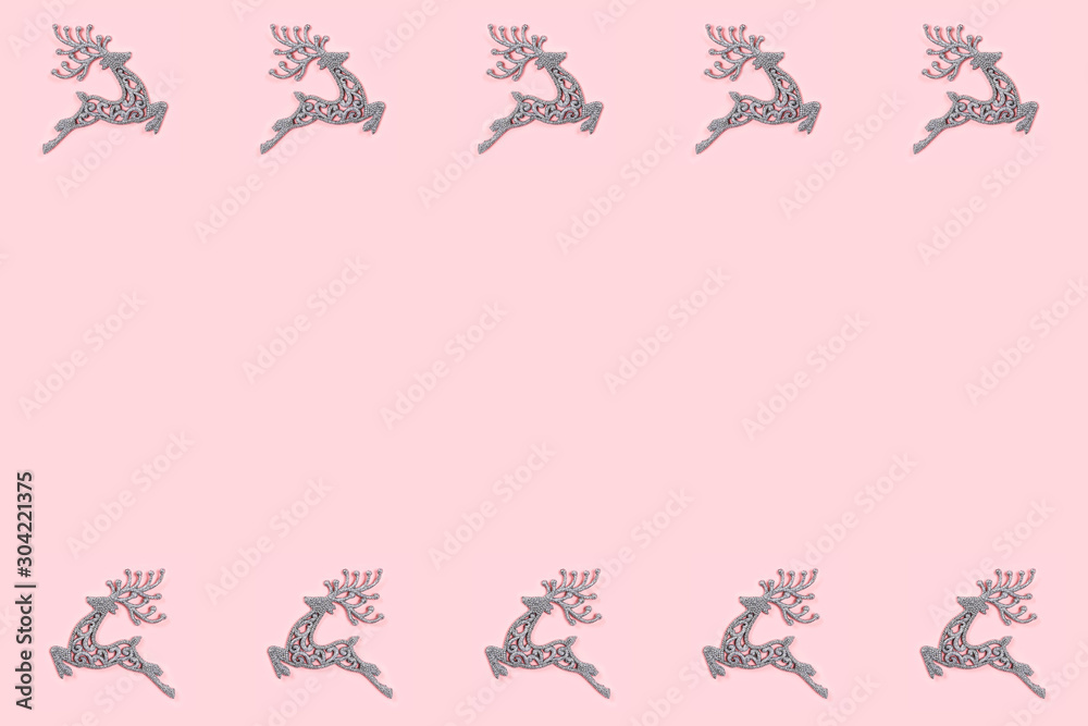Fototapeta premium Pattern made of white christmas deer decoration on pastel pink background. Christmas concept.