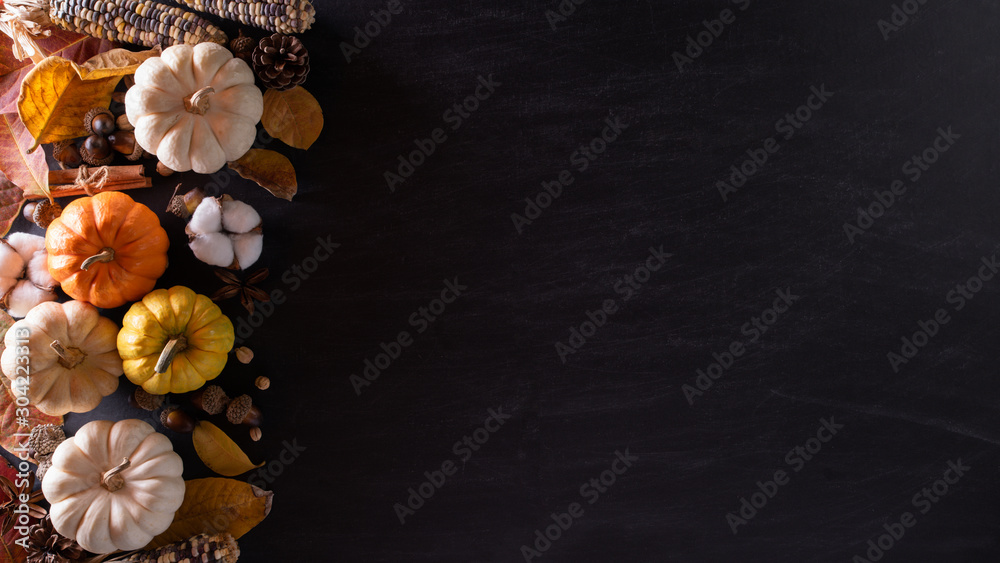 Top view of Autumn maple leaves with Pumpkin and red berries on black wooden background. Thanksgiving day concept. Top view of Autumn maple leaves with Pumpkin and red berries on black wooden background. Thanksgiving day concept.
